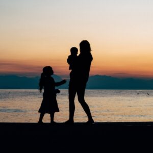 woman and children on beach shore